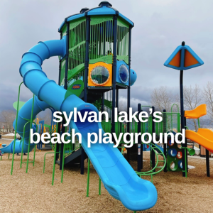 A huge slide tower rises above Sylvan Lake's Beach Playground.